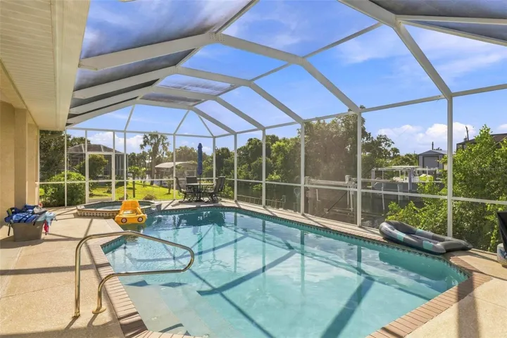 inviting pool with spillover spa hot tub