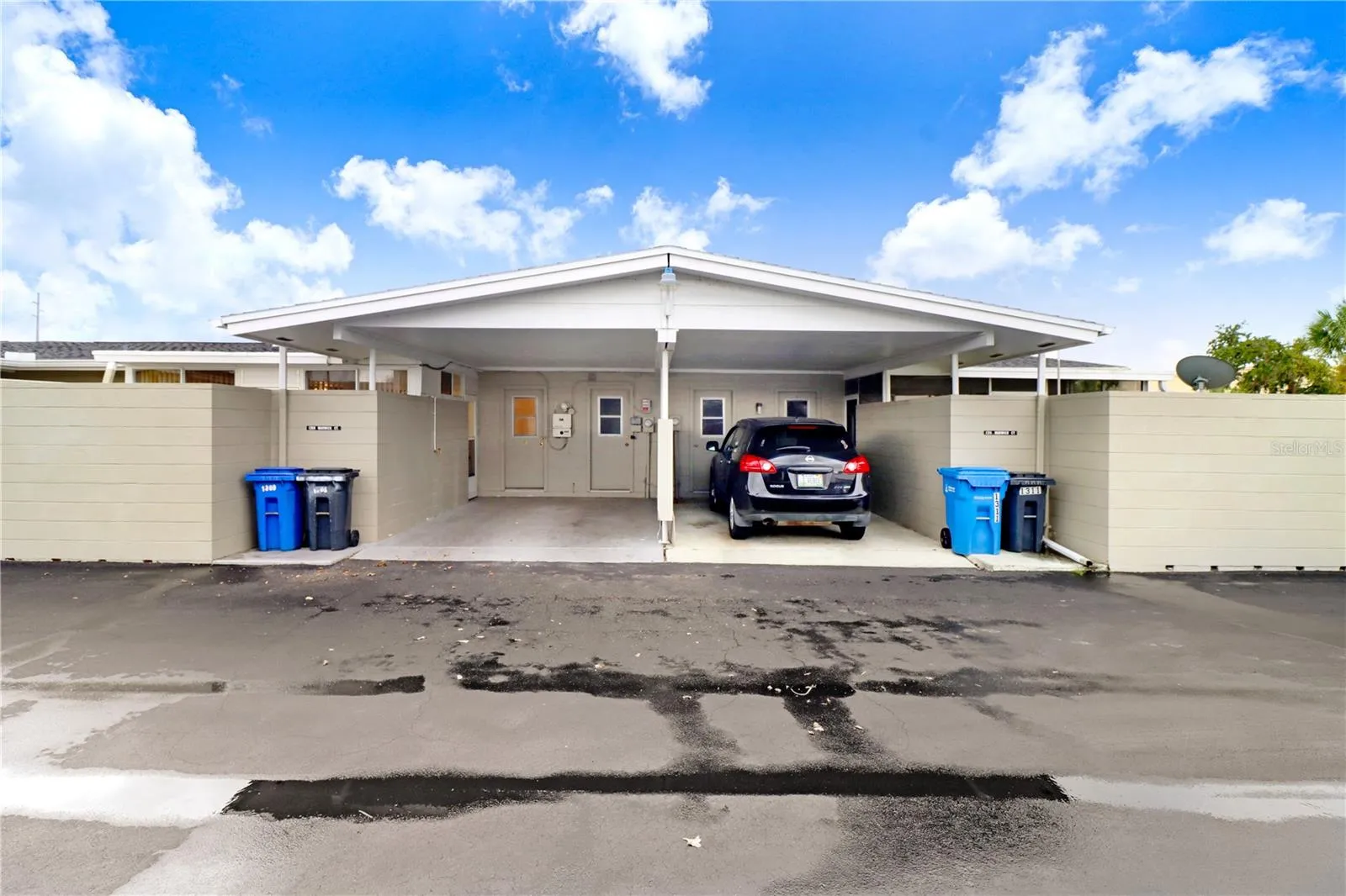 The carport on the left belongs to this listing.