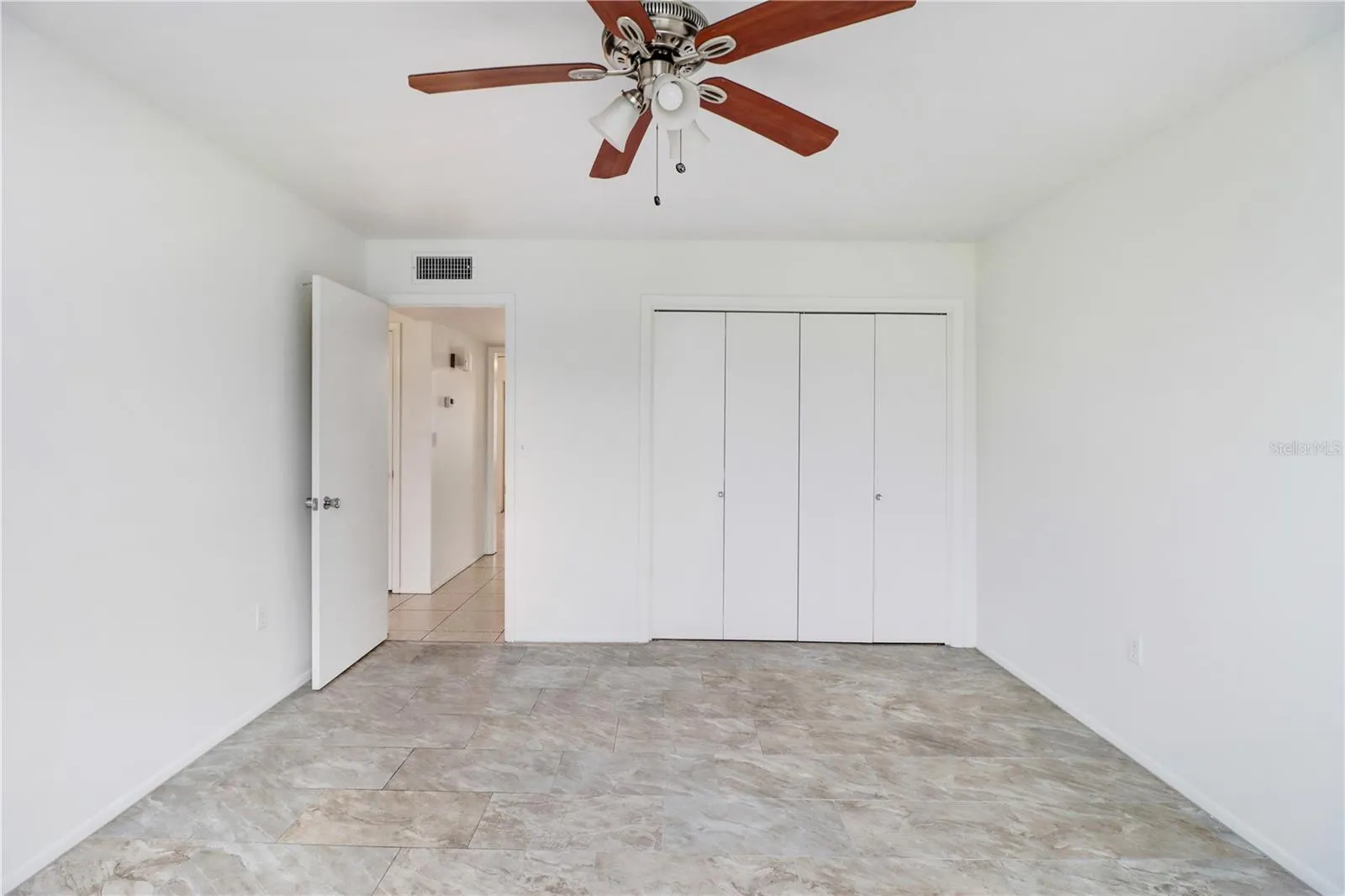 Primary bedroom featuring ample natural light and easy care tile floor.