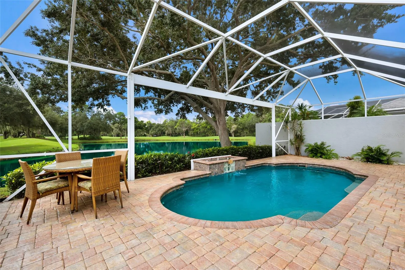 Expansive pavered lanai with panoramic screen