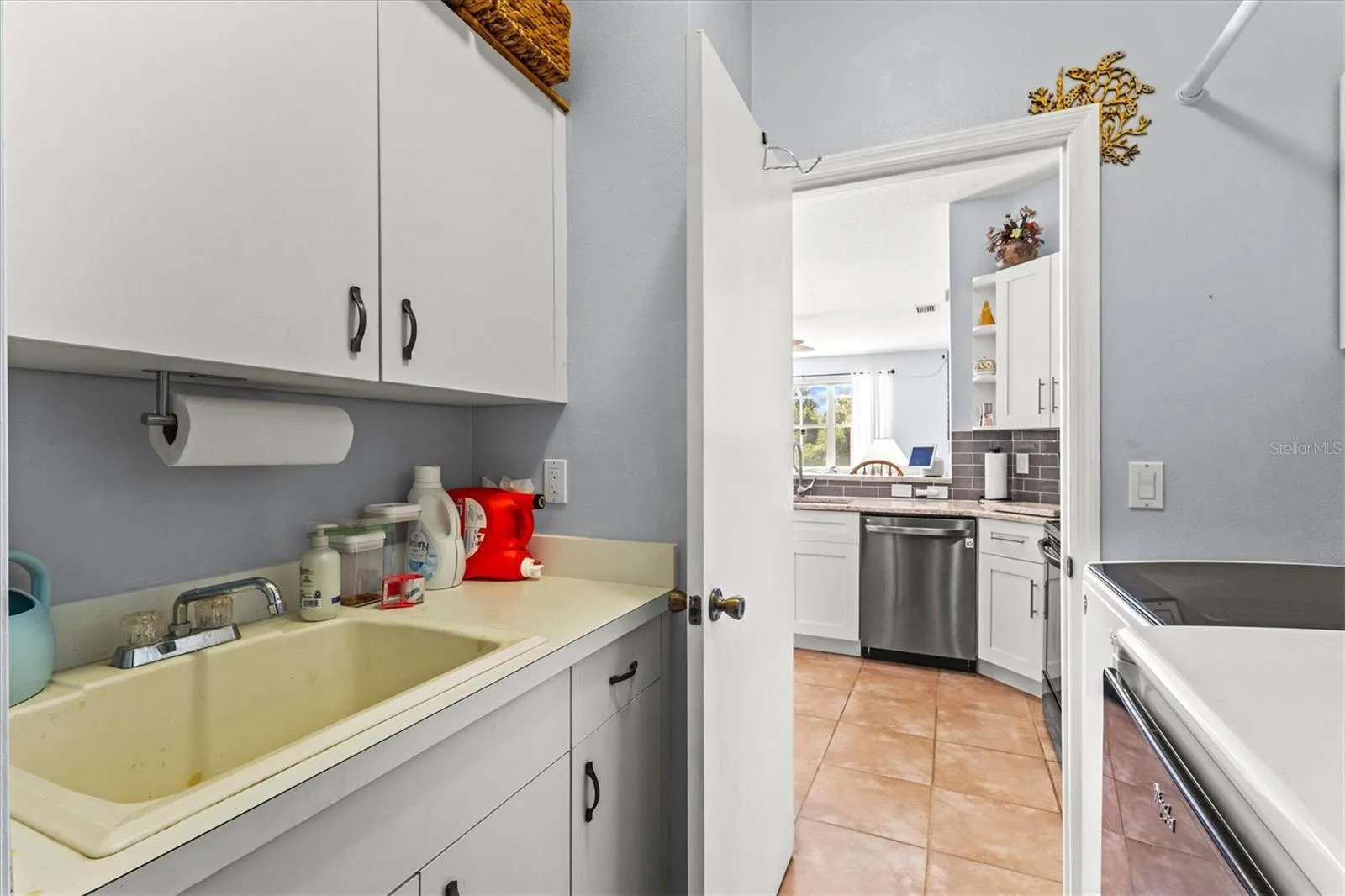 Laundry area w/ sink and plenty of storage