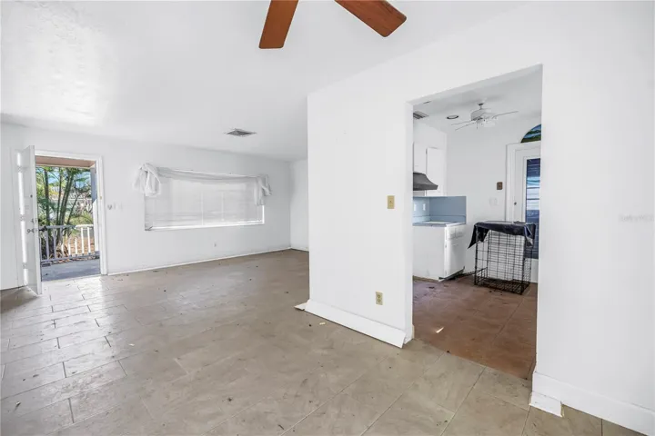 View of front door, living room, and kitchen taken from breakfast nook