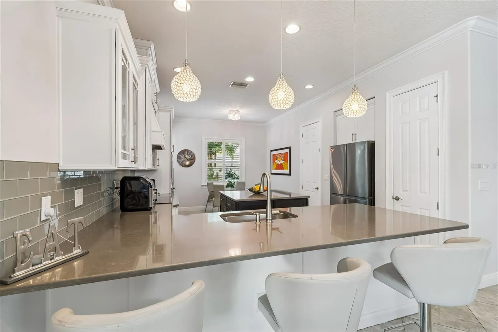 A closer look at the kitchen’s gray quartz peninsula and cabinetry.