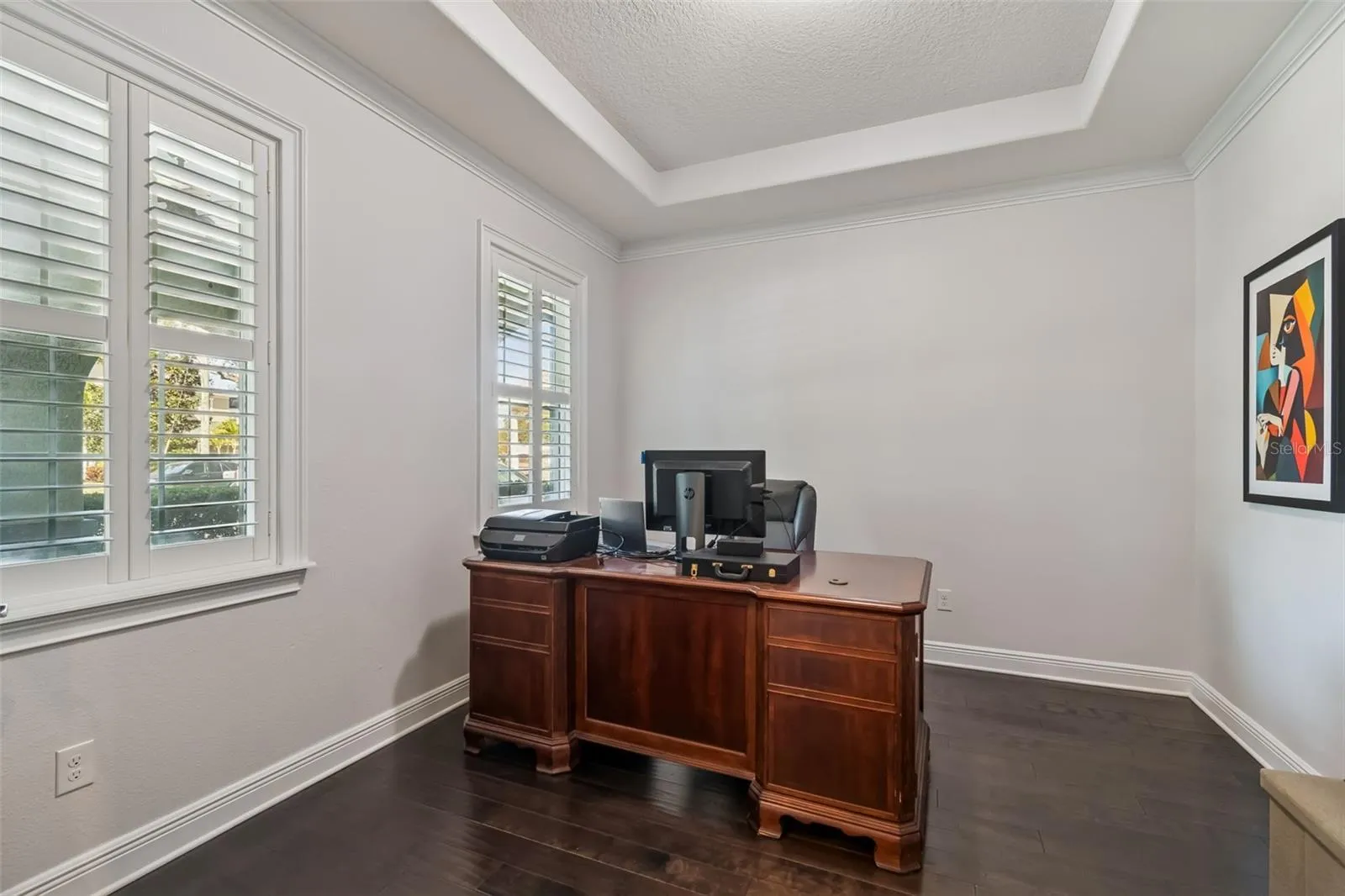 A spacious private office near the entry, set apart from the main living areas