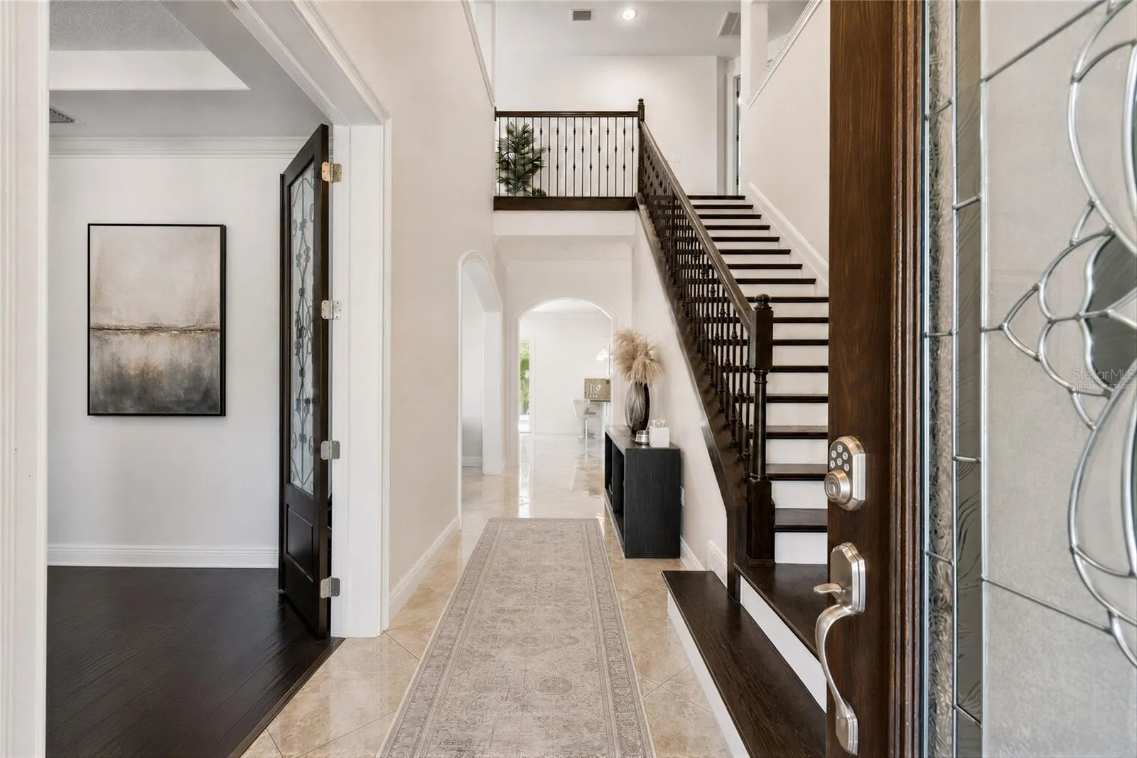 Virtually staged foyer illustrating one way to furnish the space.