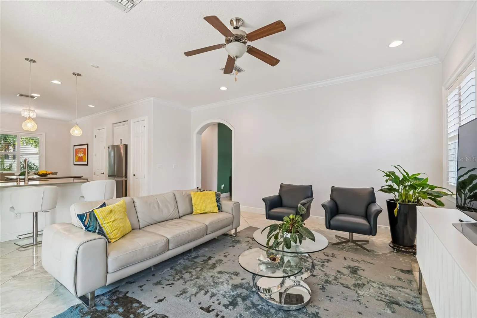 The living room opens to the kitchen, keeping both spaces connected.
