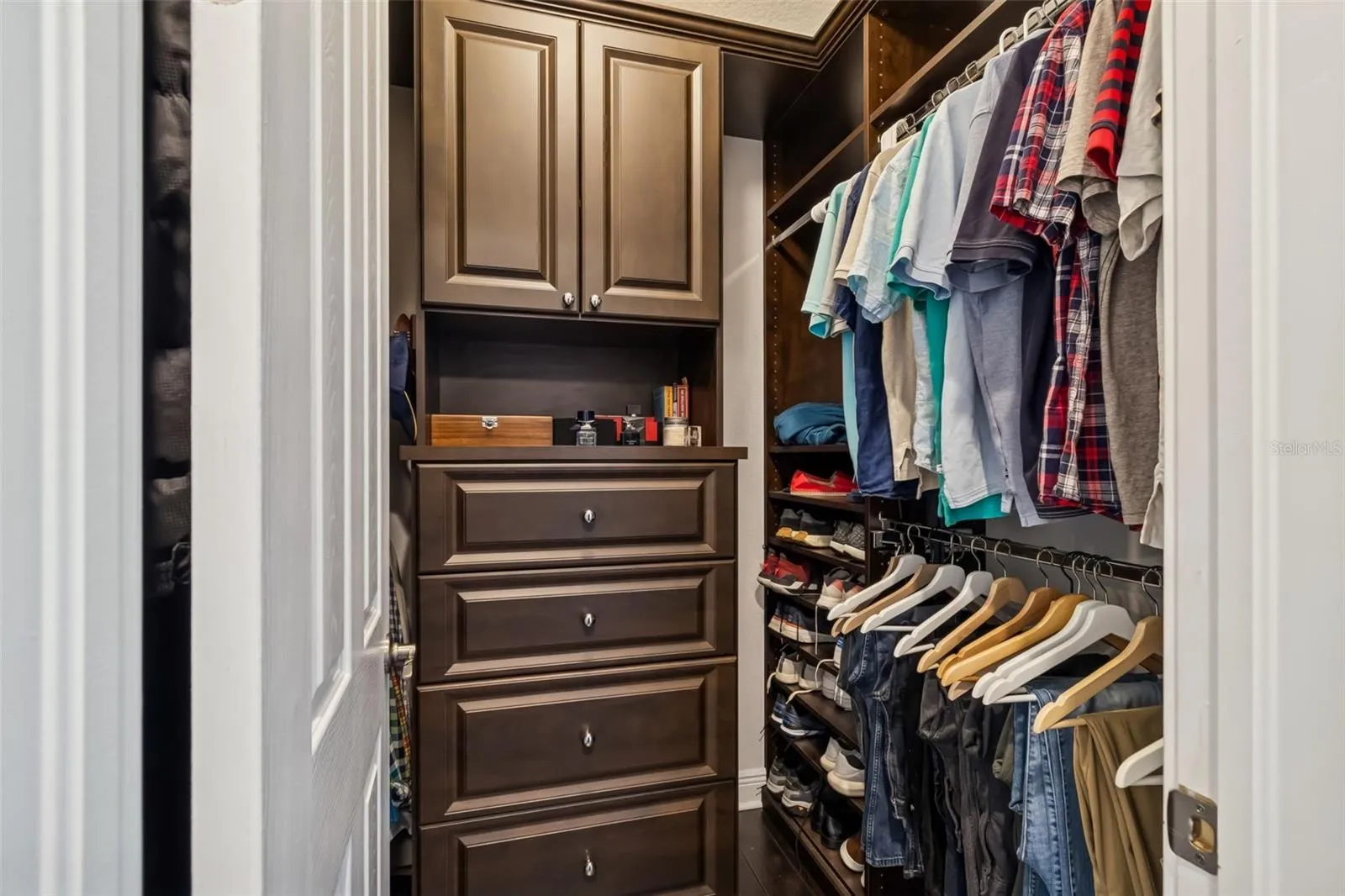 One of two primary suite closets, fitted with custom cabinetry and organizers.