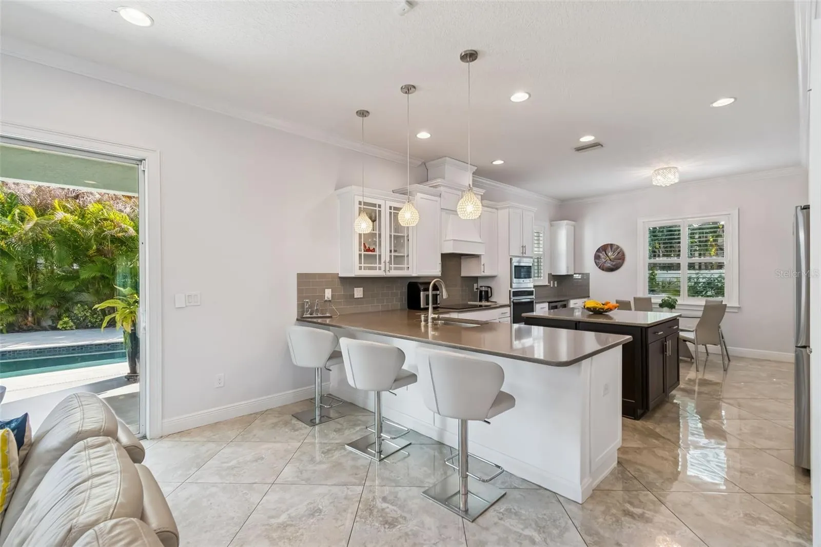 An open kitchen and living area flows through sliding doors to the backyard