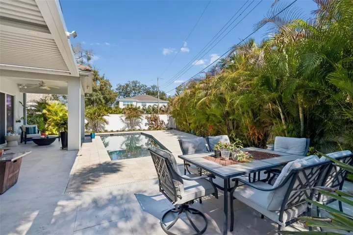 Beyond the pool, a separate outdoor dining area offers more room to gather.
