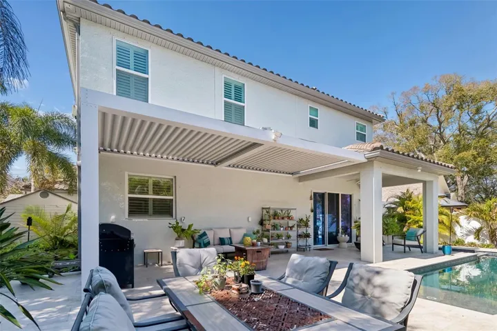 An adjustable louvered pergola lets you open the roof to the sun or close it for shade.