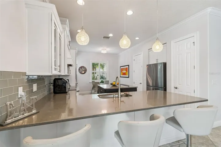 A closer look at the kitchen’s gray quartz peninsula and cabinetry.
