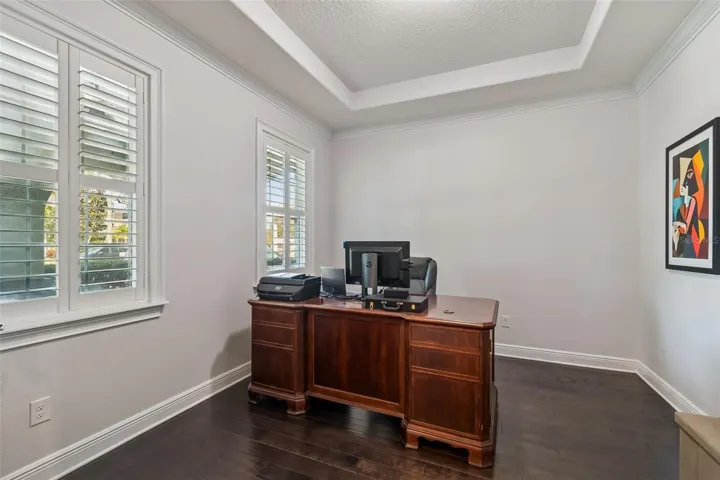 A spacious private office near the entry, set apart from the main living areas