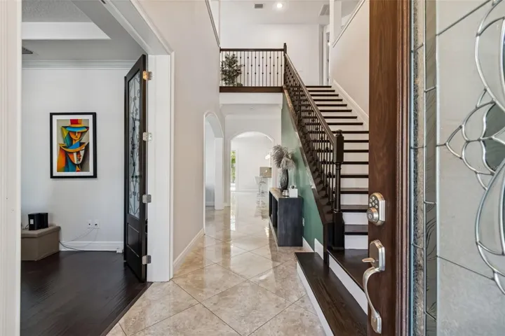 The foyer connects the private office and elegant staircase