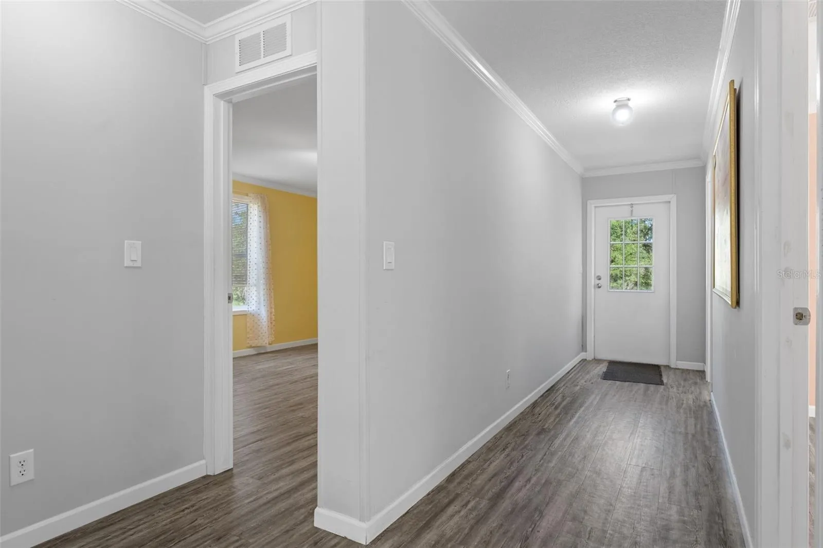 Additional view of hallway, bedroom 2 and bath 3 with LVP flooring and exterior door to pool area.