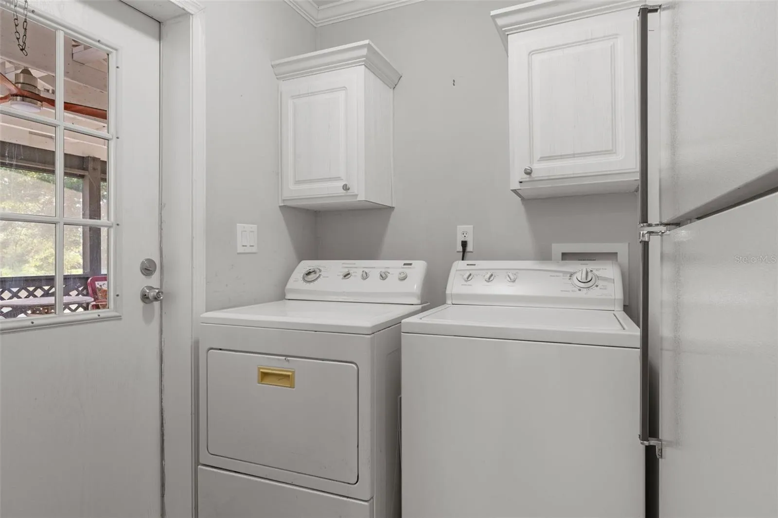 Interior laundry room conveniently located between the kitchen and screened porch.