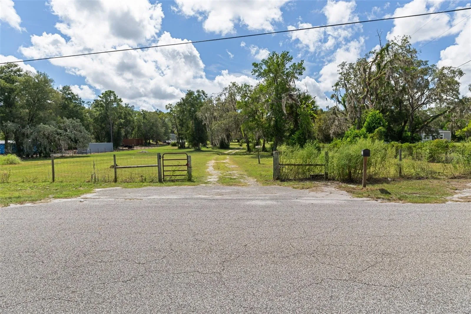 Gated entrance, drive and mature trees welcome you to all 16344 Platinum Dr has to offer: home, 3.46 acres, pool and three-bay workshop-all on one Spring Hill property
