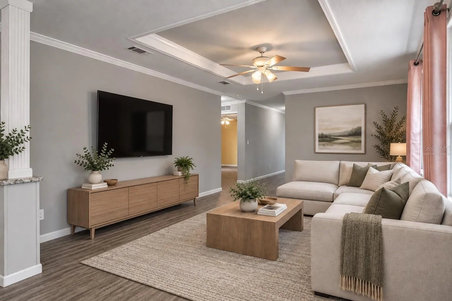 Virtually staged family room illustrates furniture placement and scale.  Furnishings and decor are digital and not included.