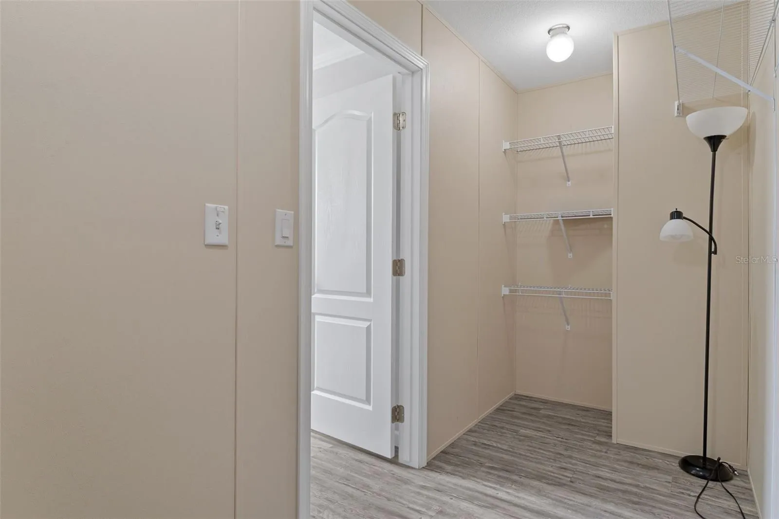 Primary walk-in closet provides dedicated storage within the primary suite.
