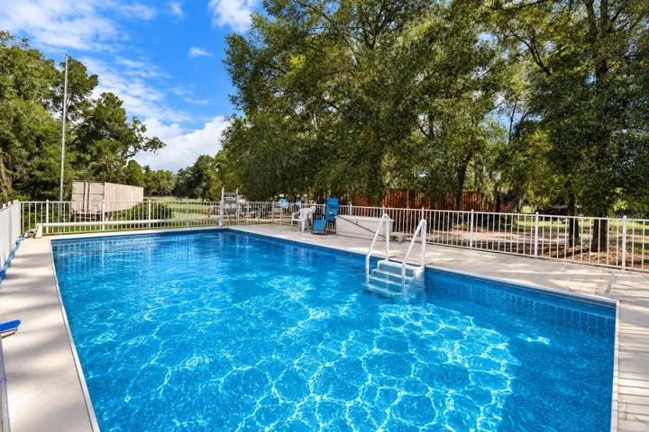 16’X32’ pool with surrounding sundeck. Pool water Virtually enhanced for presentation.