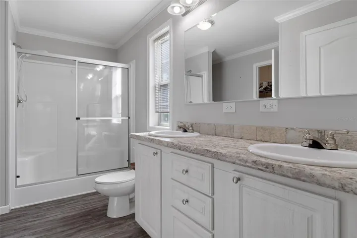 Primary bath features a walk-in shower and linen closet.