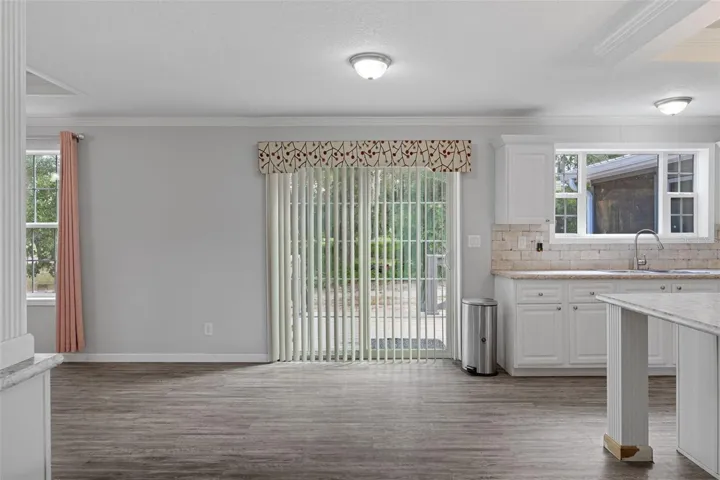 Unstaged view of the dining area with LVP flooring and no carpet.
