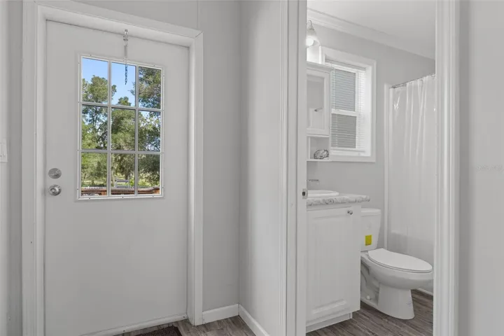 Hallway with proximity of bath 3 to door and pool area.