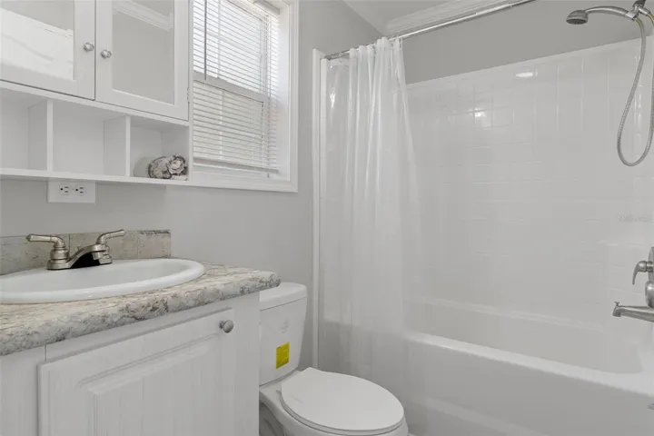 Bathroom 3 with shower tub combo convenient to pool with LVP flooring.