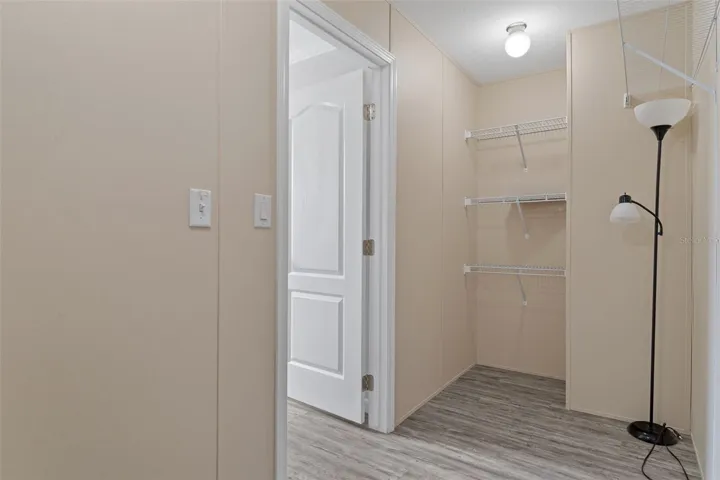 Primary walk-in closet provides dedicated storage within the primary suite.