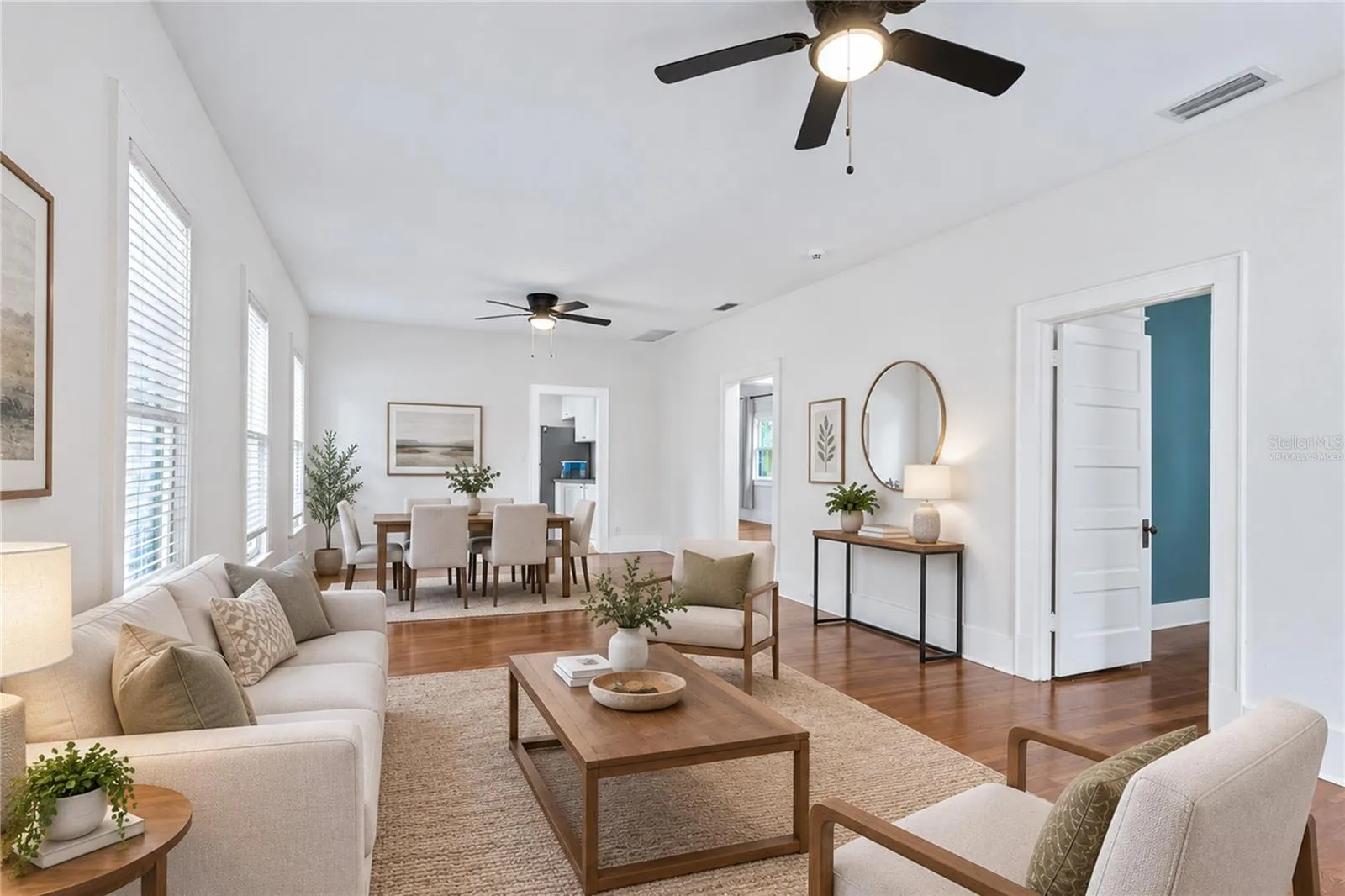 Virtually staged image. Living Room and Dining.