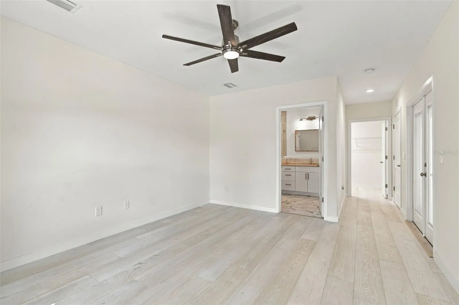 primary bdrm view of bath and closet doorways