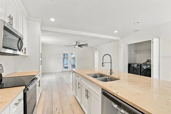View of kitchen to the living room. Note the washer and dryer - included in the purchase