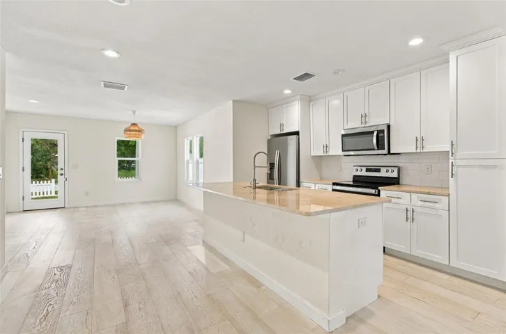 View of the kitchen and front door.
