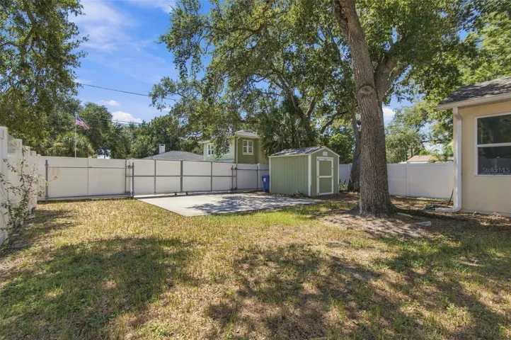 View of the large backyard and sliding gate for parkingh