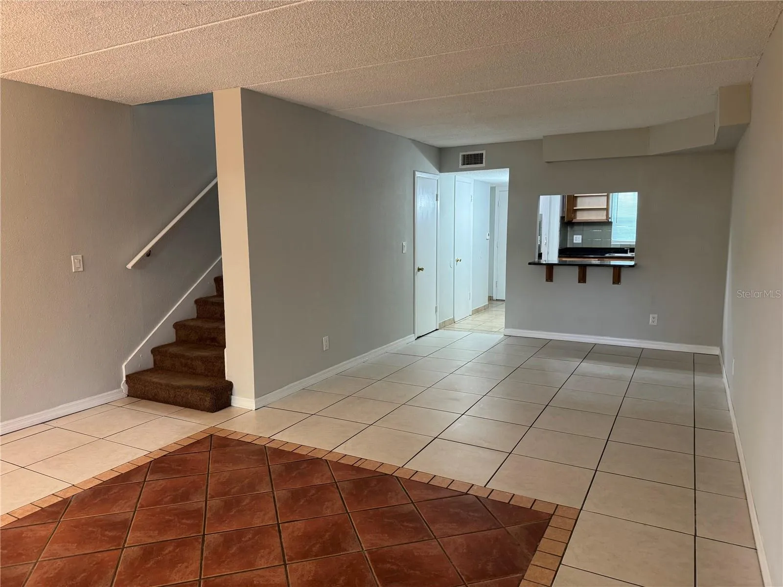 LOOKING FROM REAR PATIO THRU LOUNGING ROOM TO BREAKFAST BAR, FOYER &amp; KITCHEN