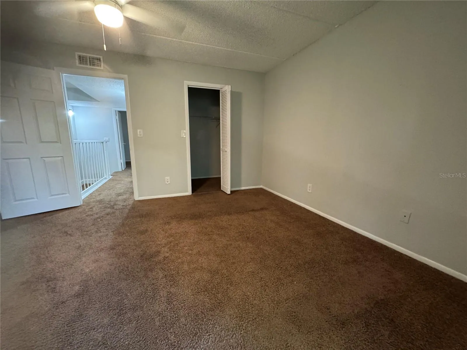 PRIMARY ROOM LOOKING FROM BALCONY TO WALK IN CLOSET