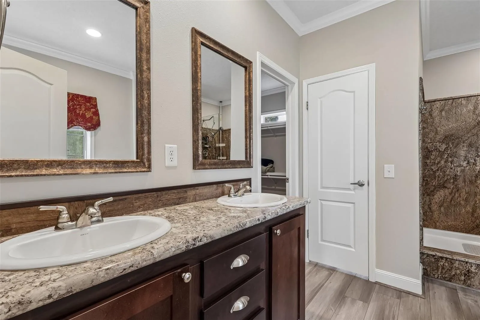 An en-suite bath boasts dual sinks, a garden tub, STEP-IN SHOWER and a PRIVATE WATER CLOSET, creating a comfortable retreat at the end of the day.