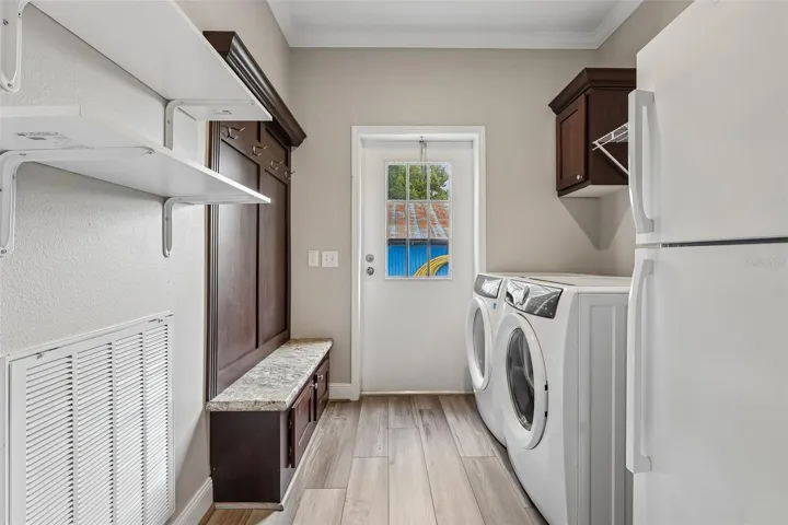 An OVERSIZED LAUNDRY ROOM WITH STORAGE adds even more everyday convenience.