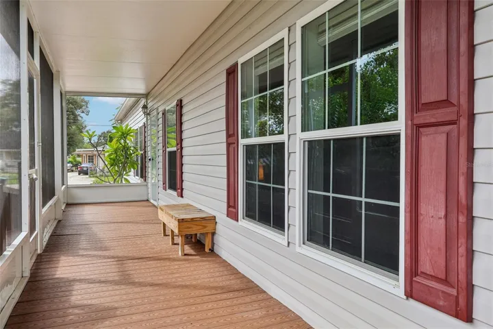 The welcoming SCREENED FRONT PORCH offers a comfortable spot to relax before stepping inside.