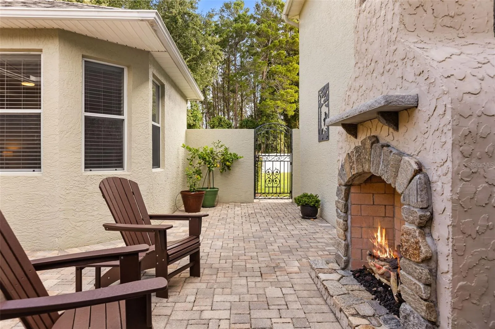 Private Courtyard with Stone Gas Fireplace, Paver Patio &amp; 2 Handmade Copper Gas Lanterns