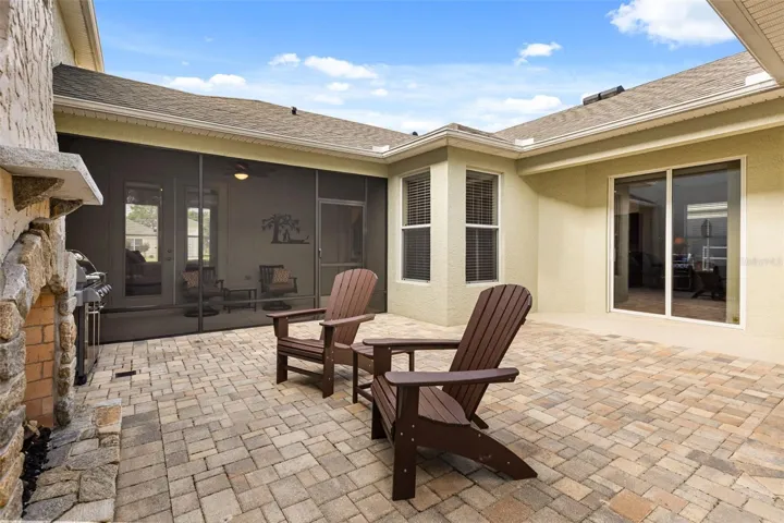 Private Paver Courtyard with Gas Fireplace and Screened Lanai