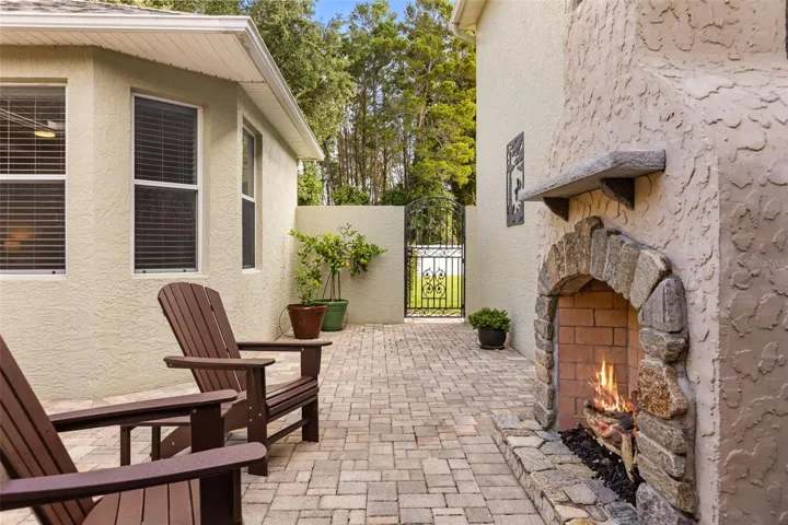 Private Courtyard with Stone Gas Fireplace, Paver Patio &amp; 2 Handmade Copper Gas Lanterns