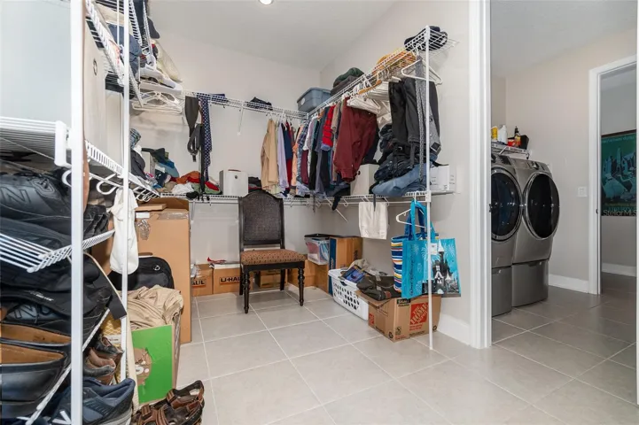 Huge Primary Bedroom Walk in Closet that connects to Laundry Room. Laundry Room connects to hallway with 2 other bedrooms and a bath