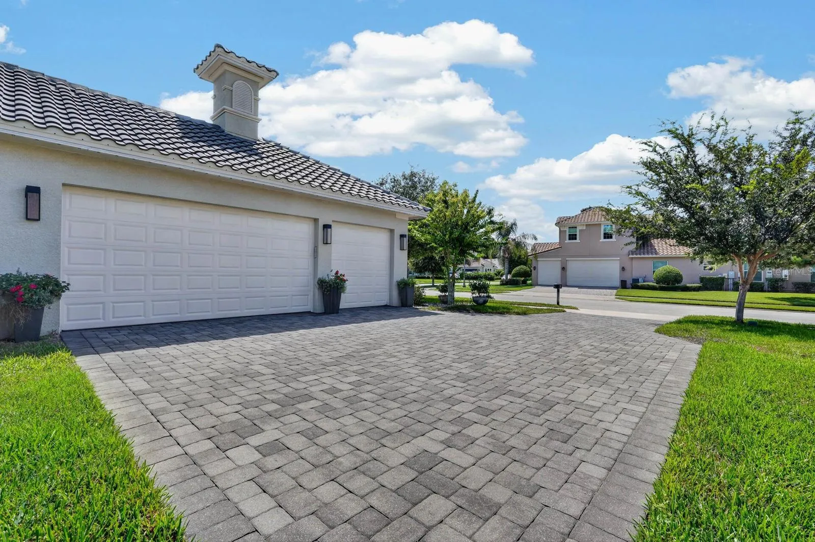 paver driveway offers plenty of room for guest parking plus a 3 car garage