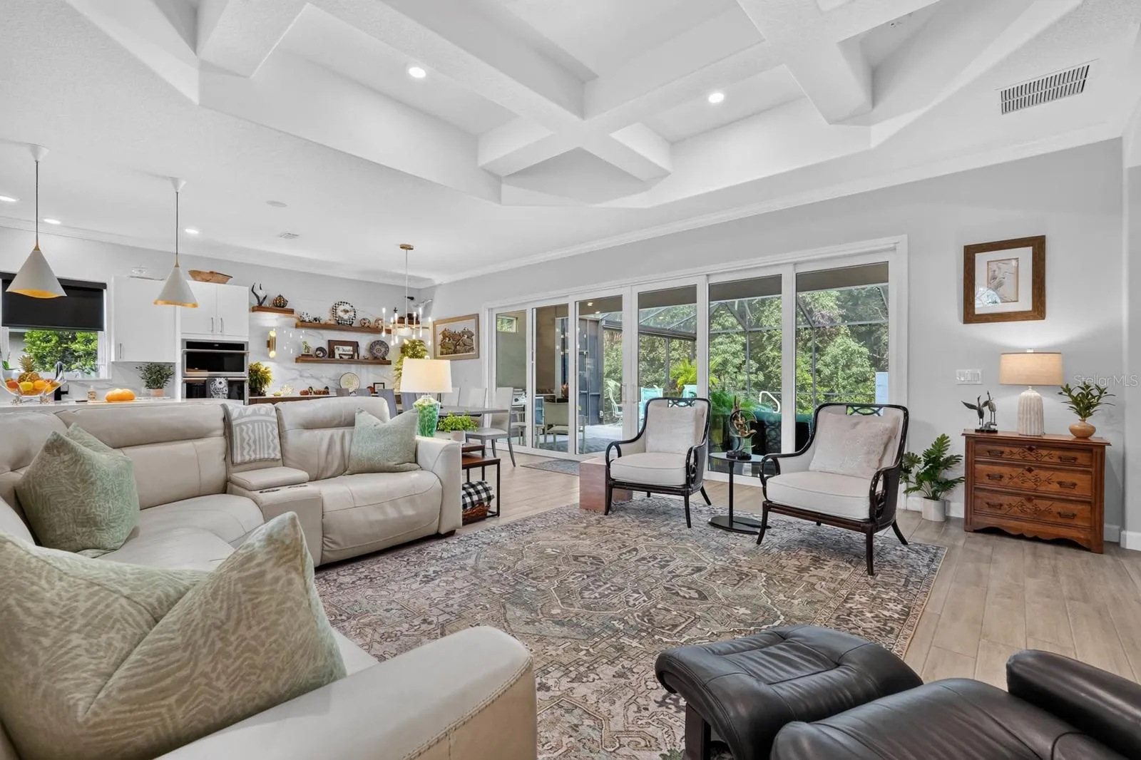 This large great room features a wall of sliders that open up into the private backyard space