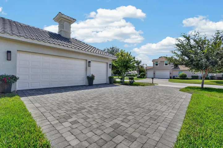 paver driveway offers plenty of room for guest parking plus a 3 car garage