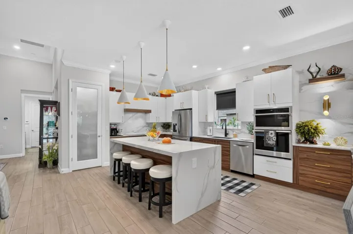Beautiful chef's kitchen features porcelain countertops and backsplash