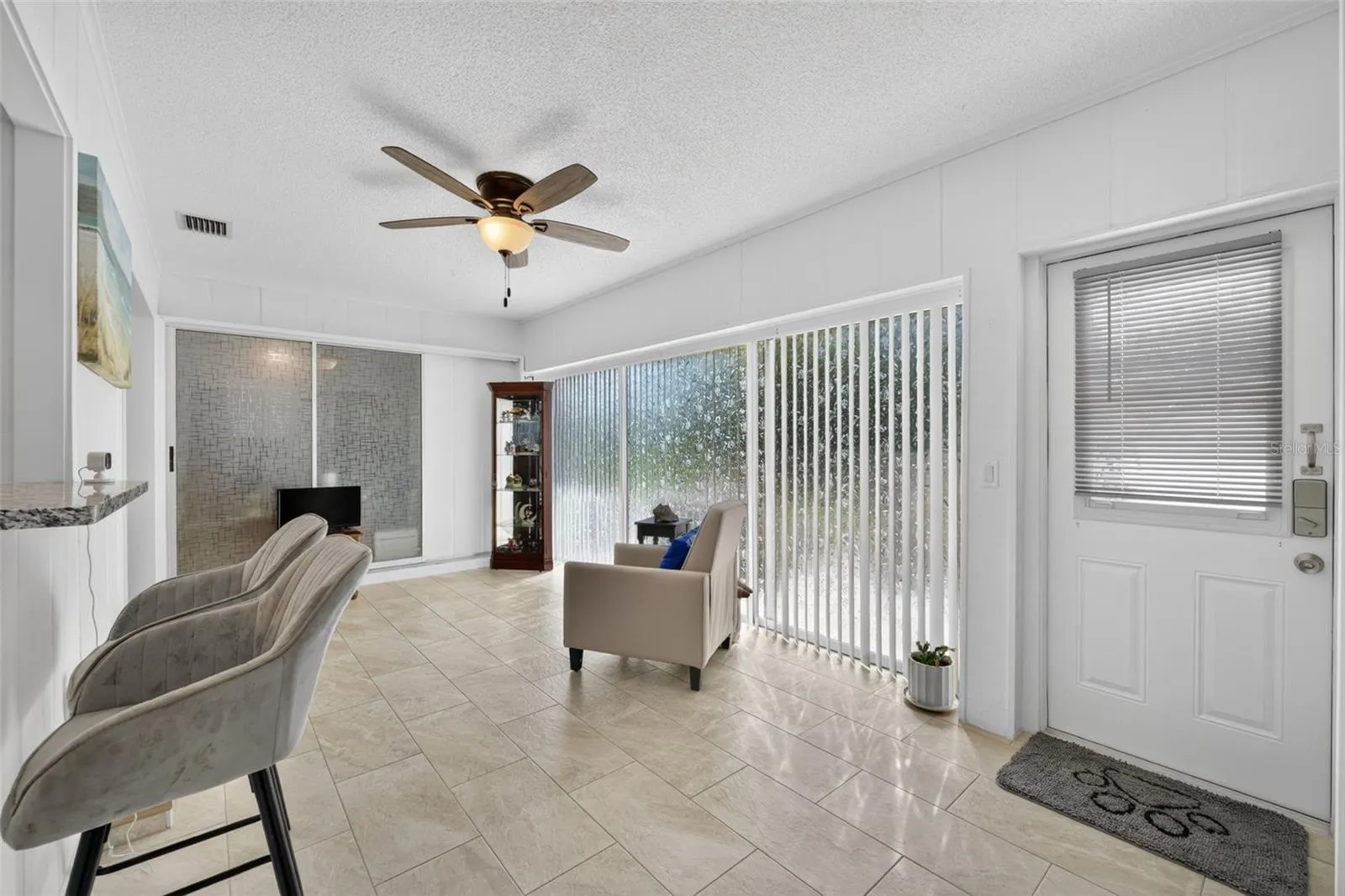 Family room with slider doors and door leading to patio