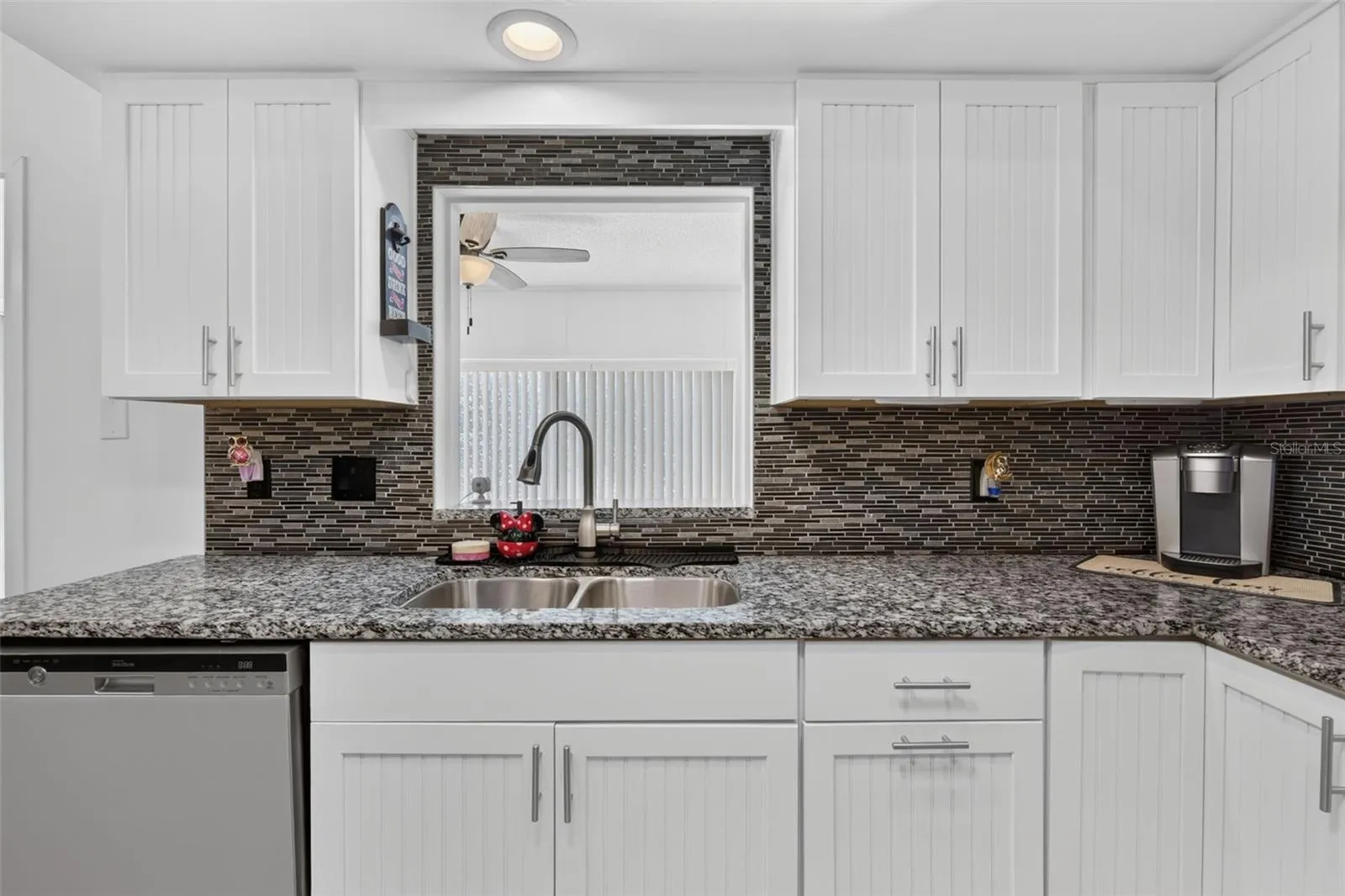 Kitchen sink with opening looking out to family room