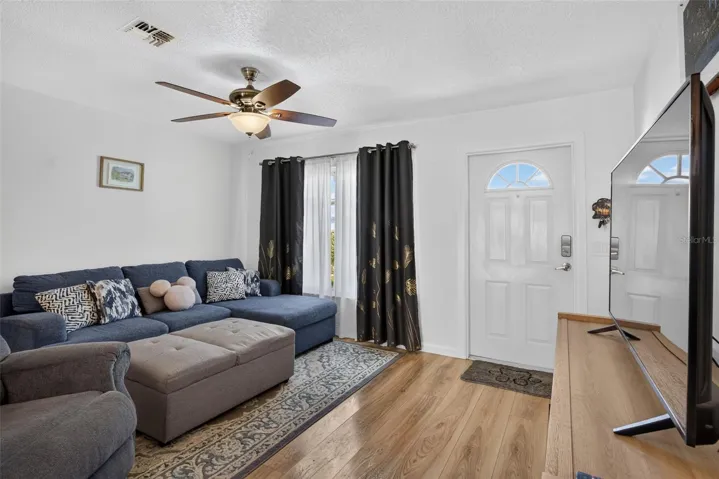 Living room showing entryway of front door