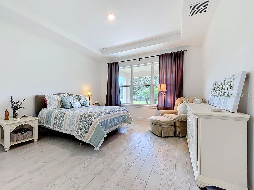 Primary Suite, w/Tray Ceiling and Large Window, and Tile Flooring